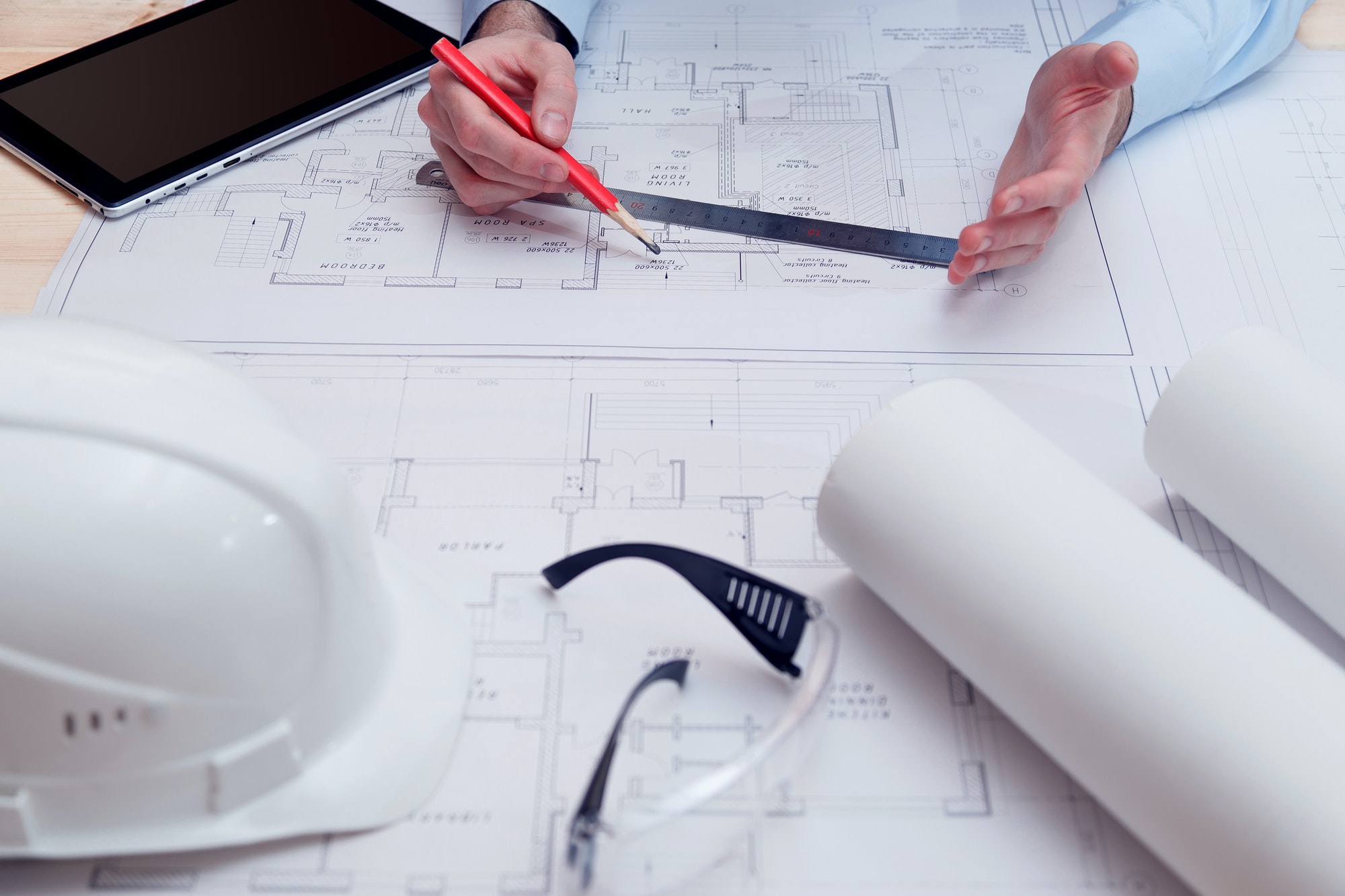 Chief engineer or architect works with building drawings